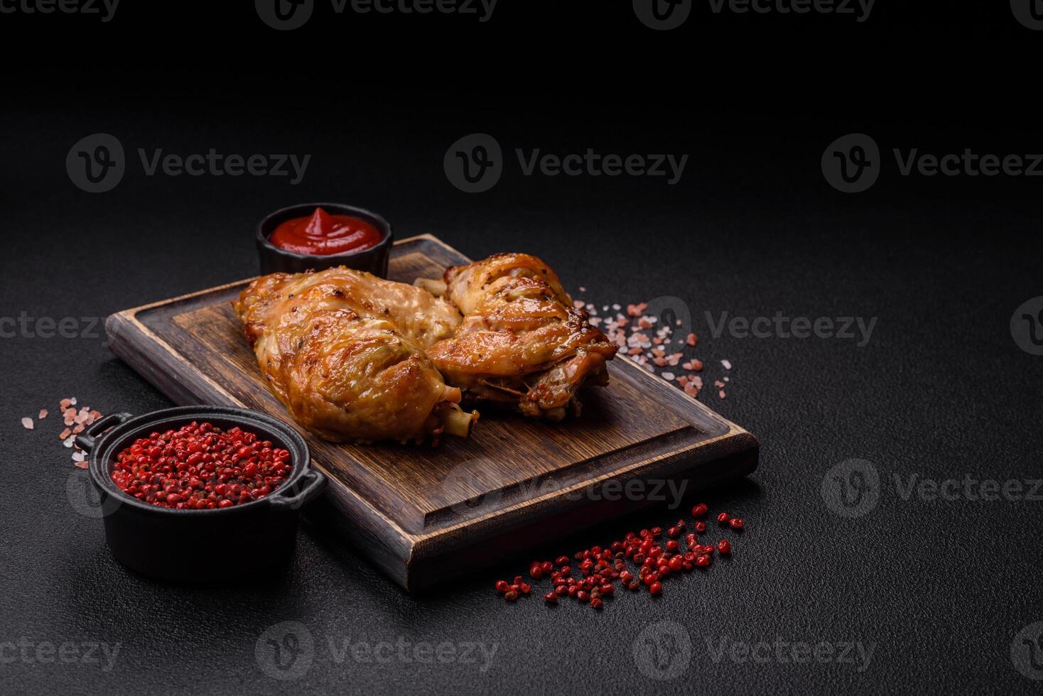Delicious grilled chicken leg or quarter with salt and spices photo