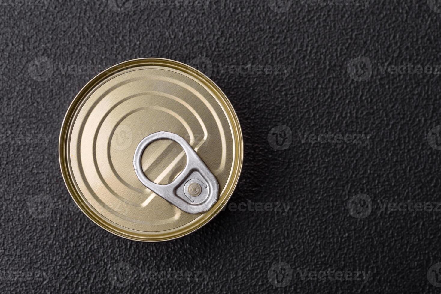 Round metal can with canned meat or fish with a key photo
