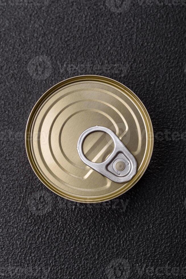 Round metal can with canned meat or fish with a key photo