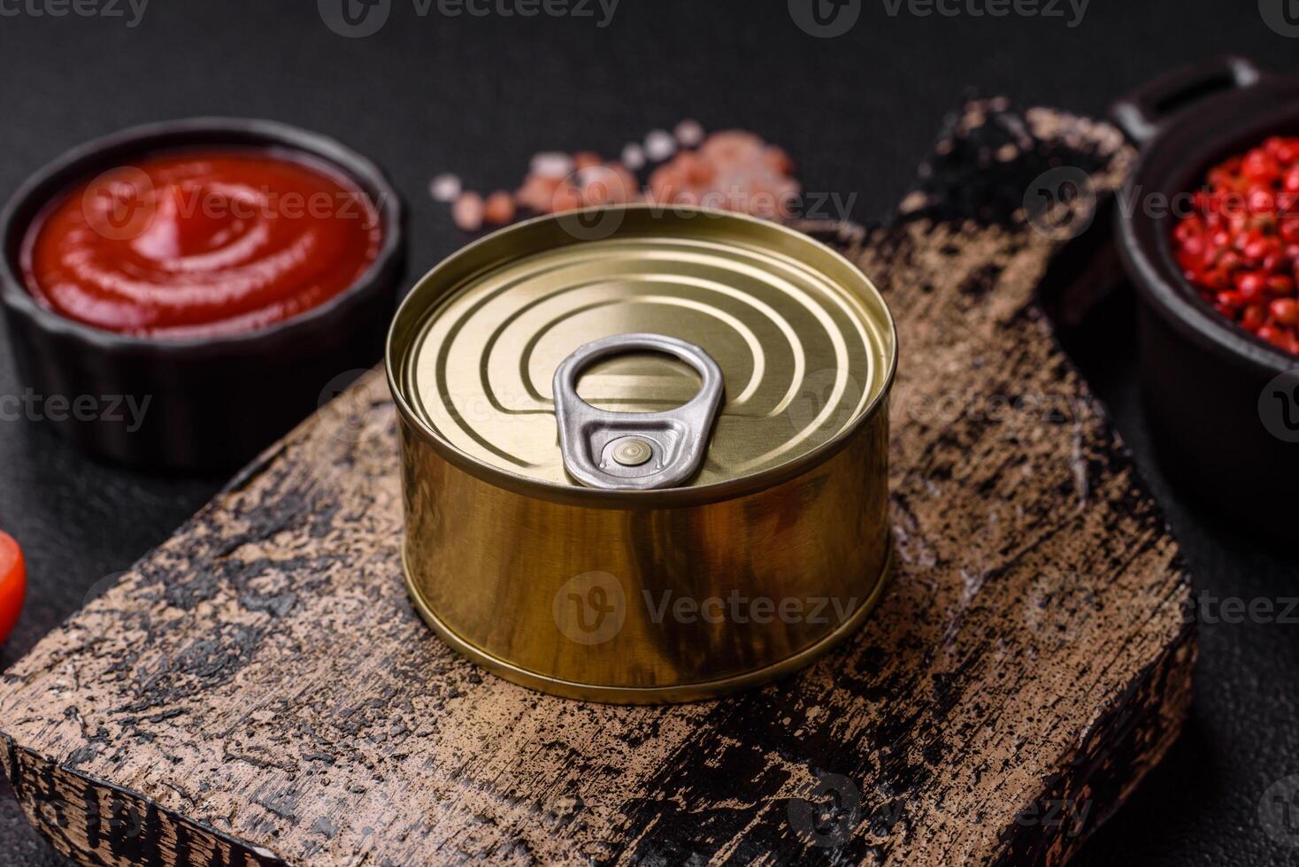 Round metal can with canned meat or fish with a key photo