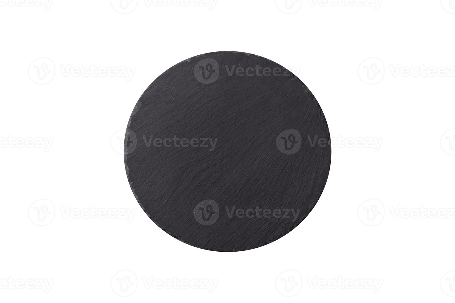 Empty round slate plate for template on the black background photo
