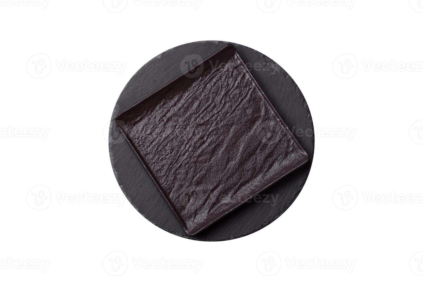 Empty round slate plate for template on the black background photo