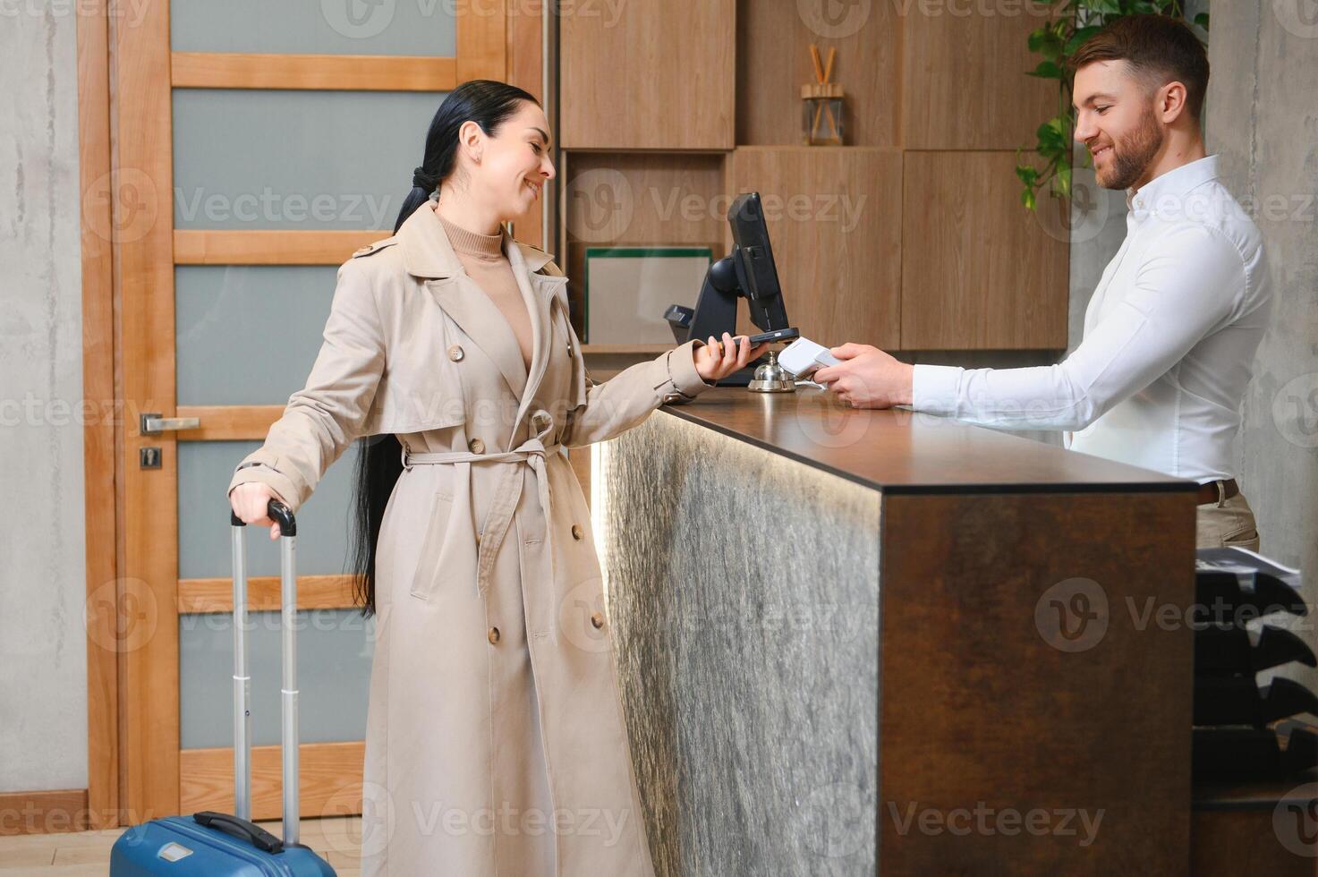 Picture of guests getting key card in hotel photo