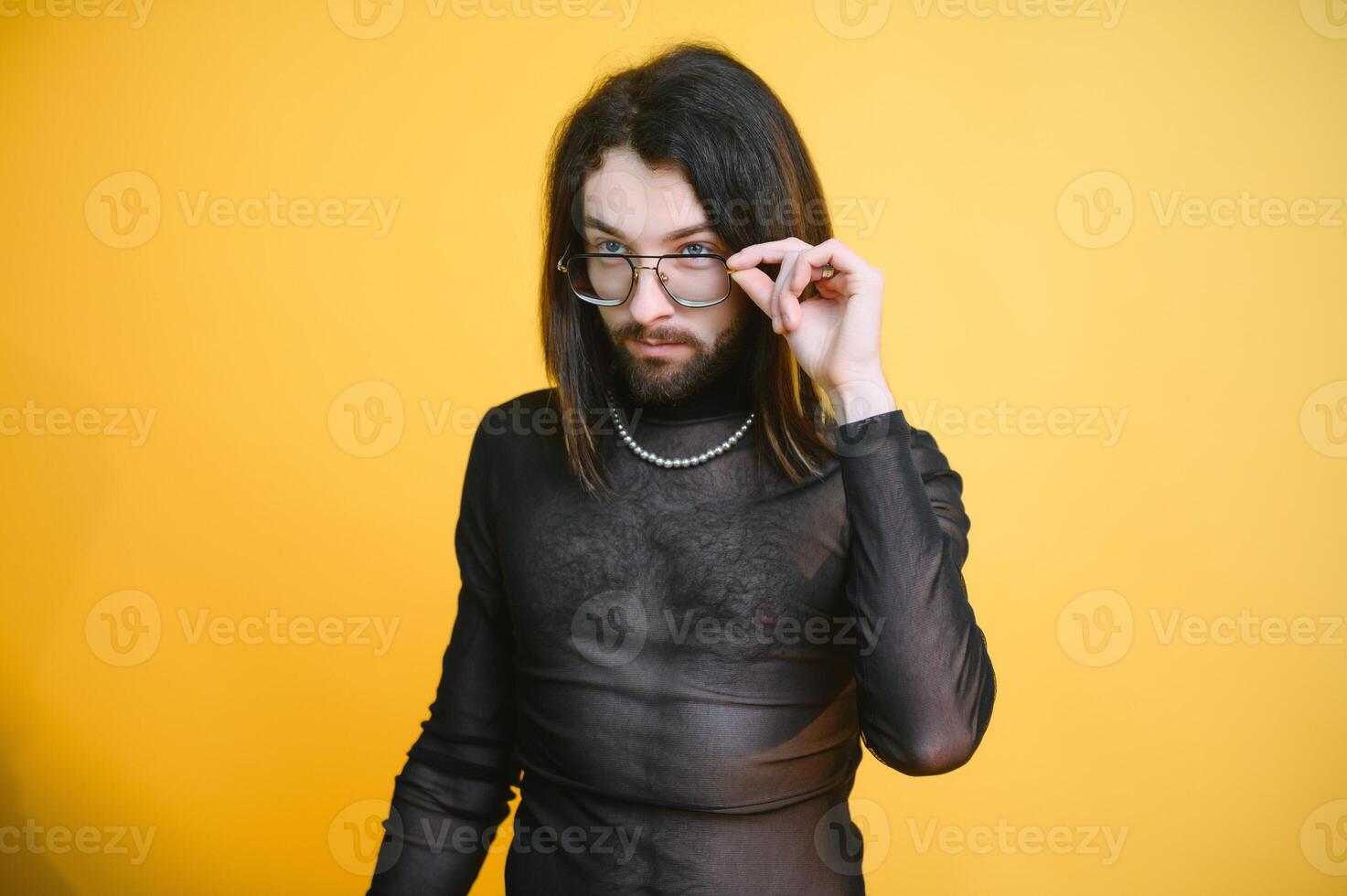 Gay man hold rainbow striped flag isolated on colored background studio portrait. People lifestyle fashion lgbtq concept photo