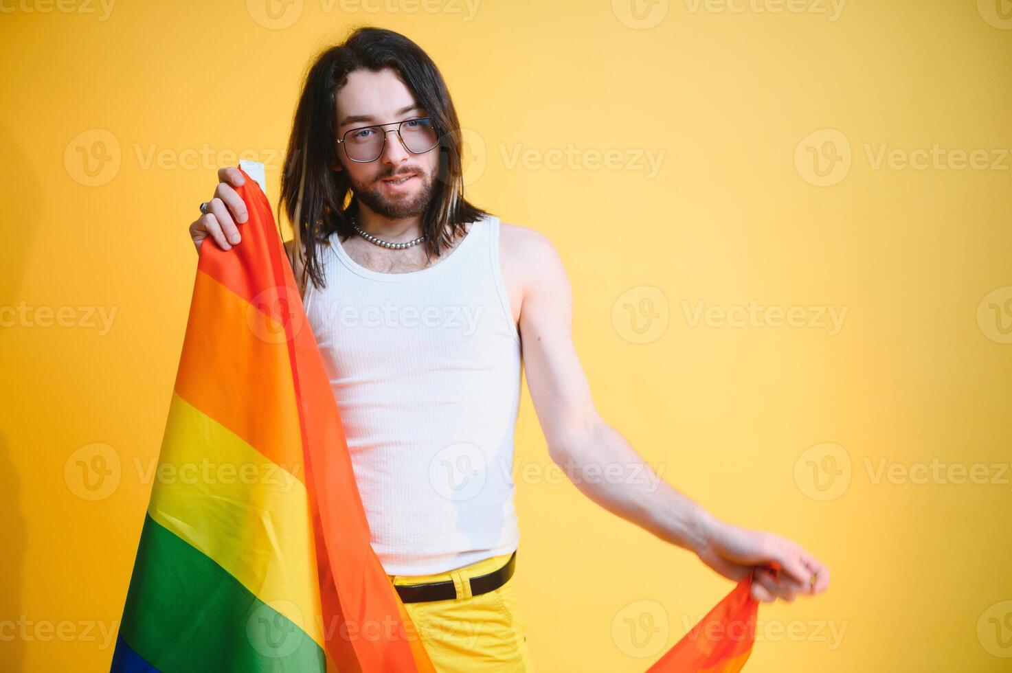 Youth transgender LGBT with Rainbow flag on shoulder isolated color background. gender expression pride and equality concept. photo