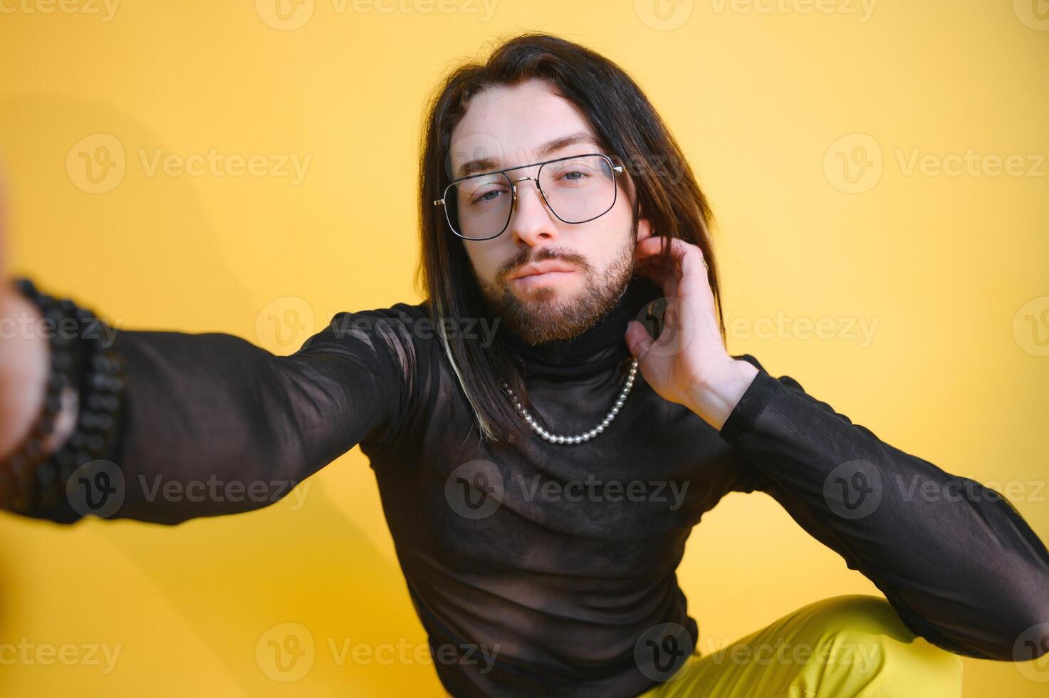 Gay man on a colored background in the studio. The concept of the LGBTQ community. Equality. photo
