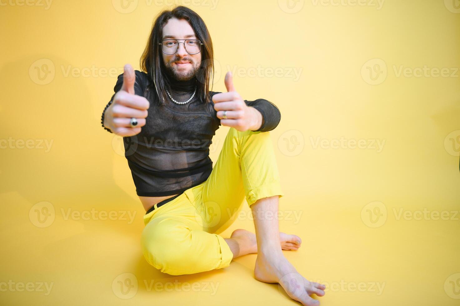 Gay man hold rainbow striped flag isolated on colored background studio portrait. People lifestyle fashion lgbtq concept photo