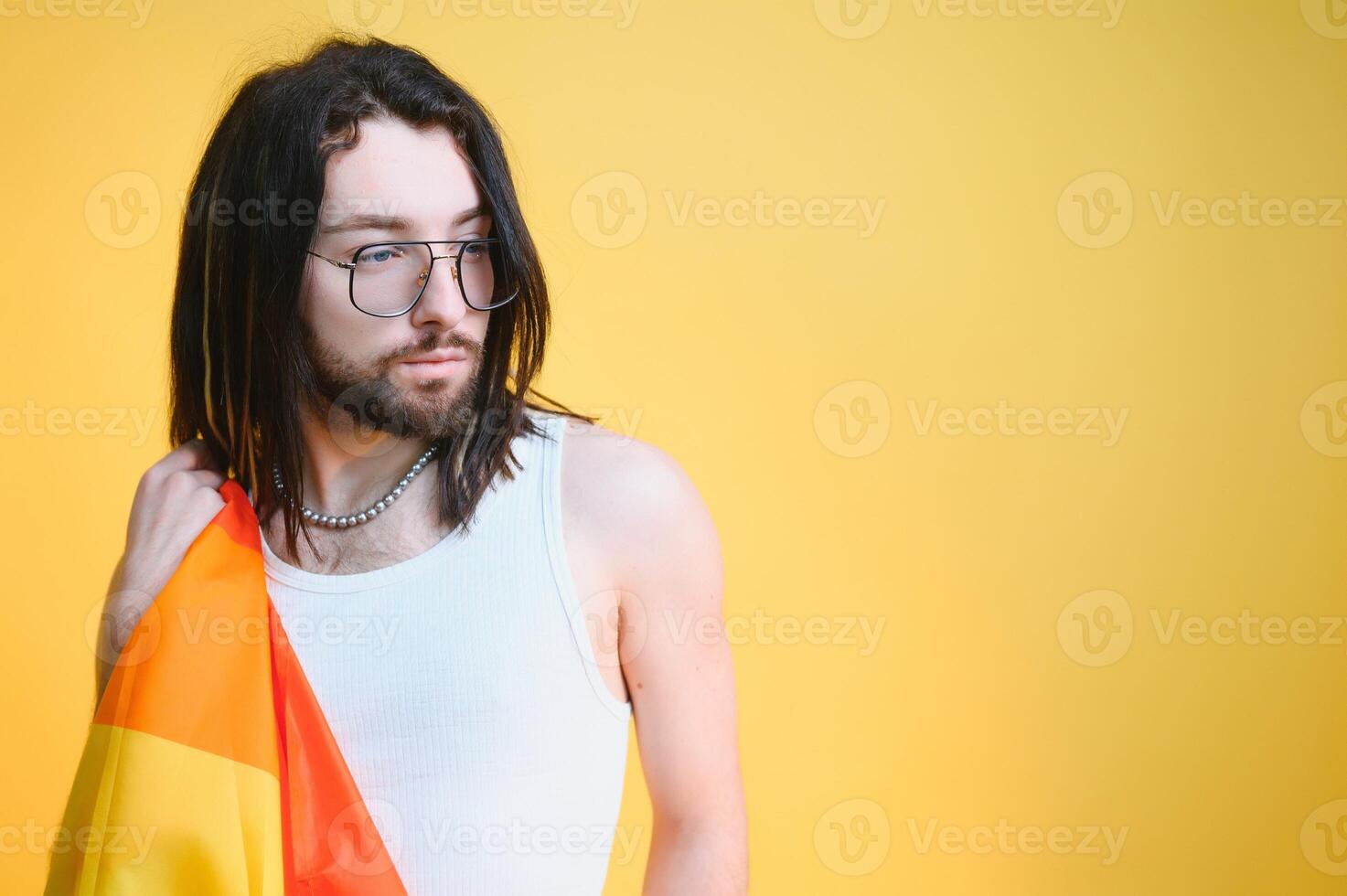 Youth transgender LGBT with Rainbow flag on shoulder isolated color background. gender expression pride and equality concept. photo
