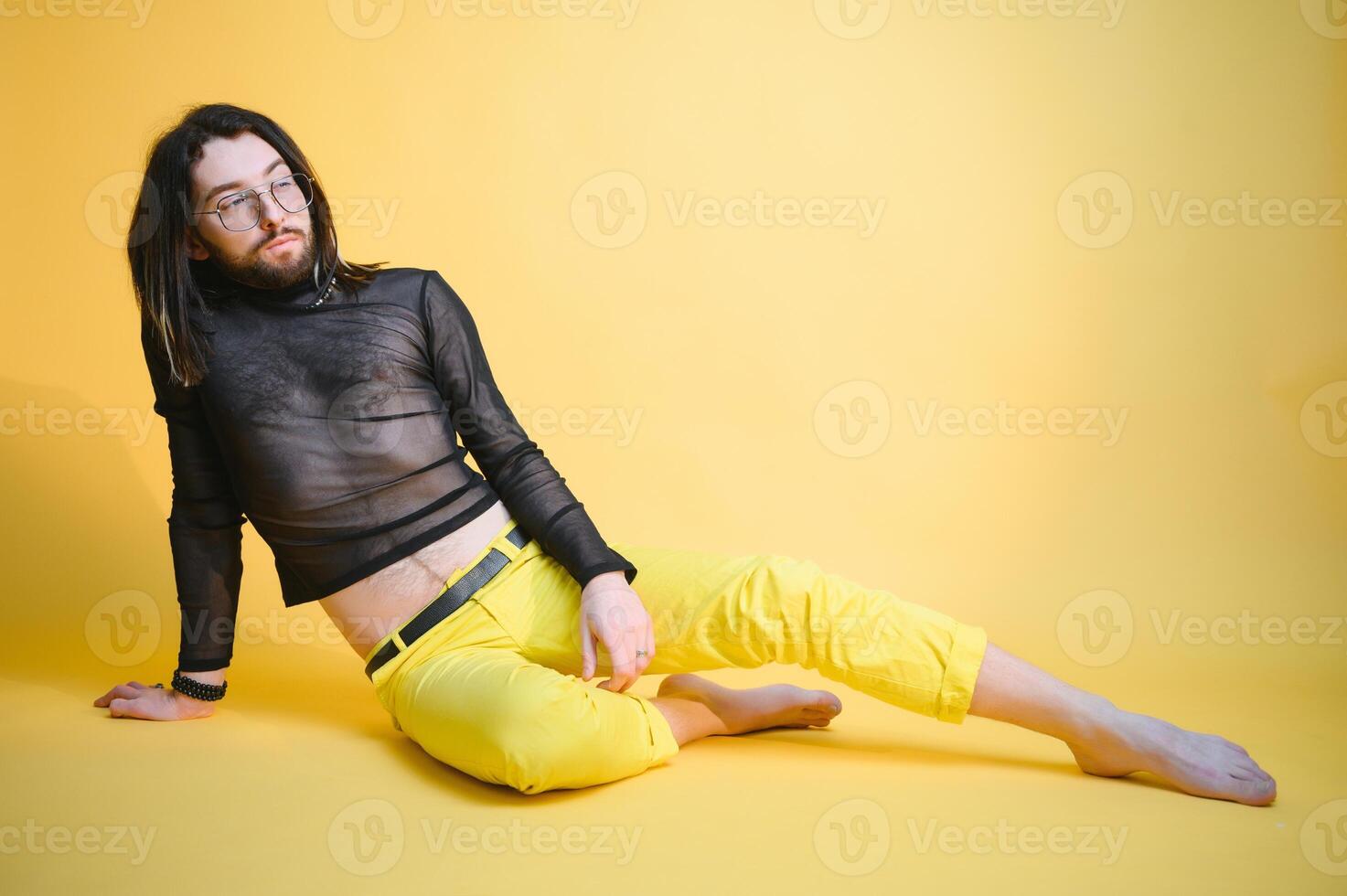 Young, handsome gay man on a colored background in the studio. LGBT concept. photo
