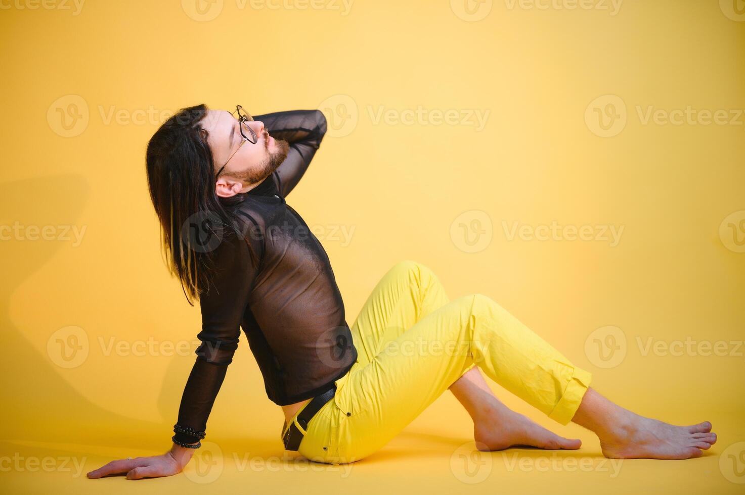 Young, handsome gay man on a colored background in the studio. LGBT concept. photo