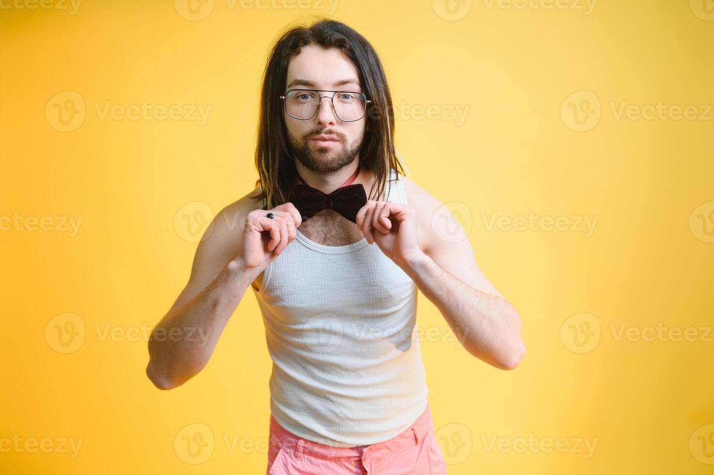 Young, handsome gay man on a colored background in the studio. LGBT concept. photo
