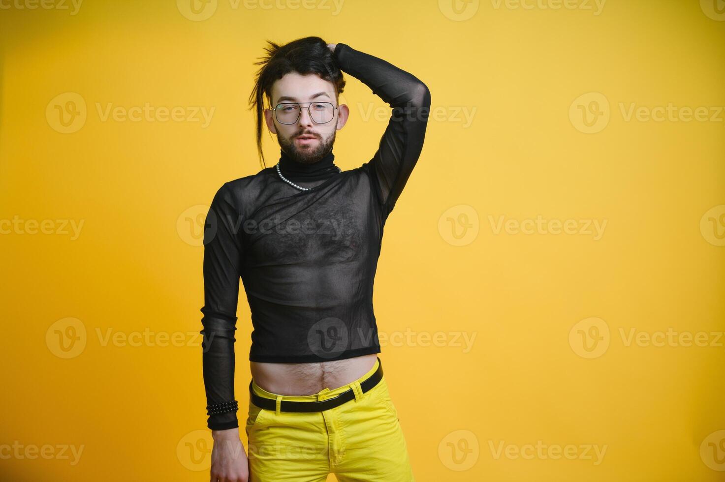 Gay man on a colored background in the studio. The concept of the LGBTQ community. Equality. photo