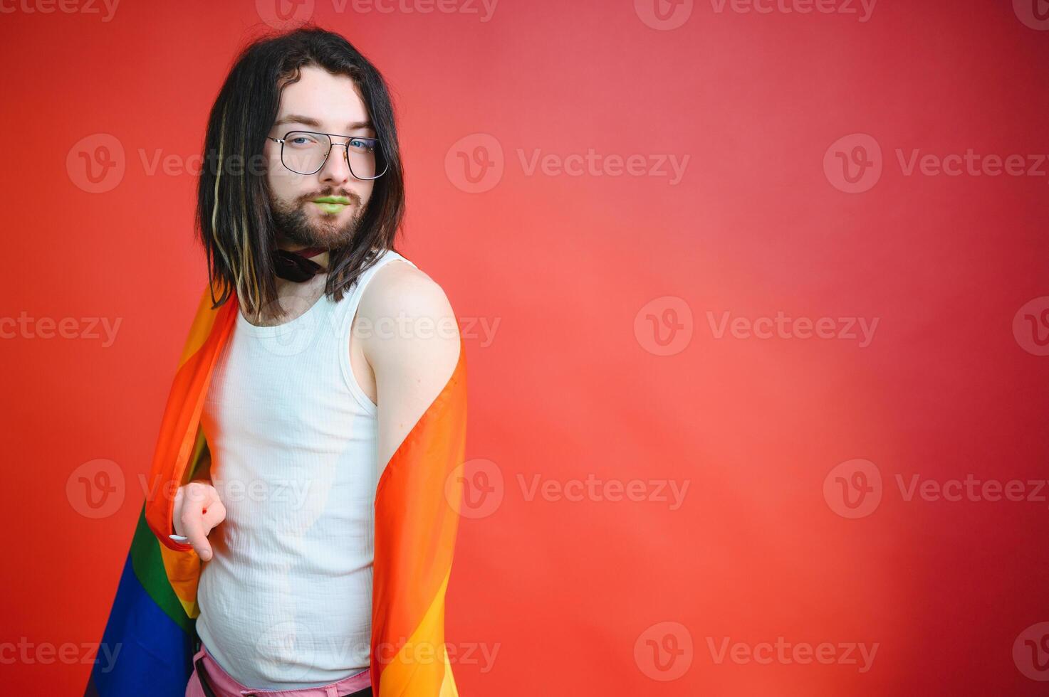 Youth transgender LGBT with Rainbow flag on shoulder isolated color background. gender expression pride and equality concept. photo