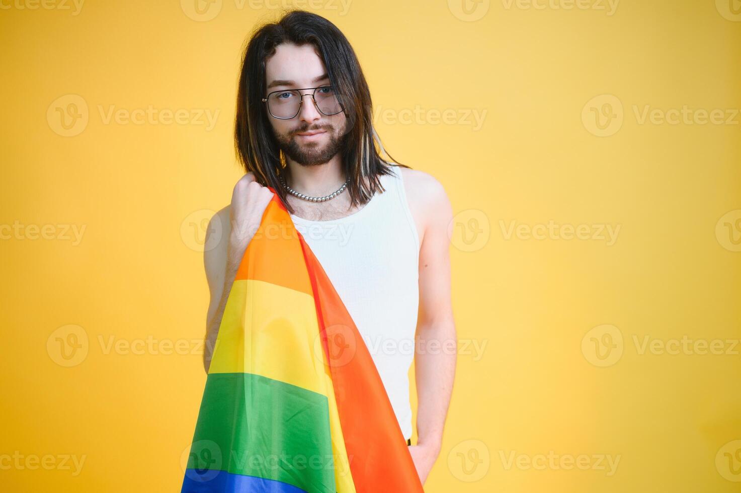Youth transgender LGBT with Rainbow flag on shoulder isolated color background. gender expression pride and equality concept. photo