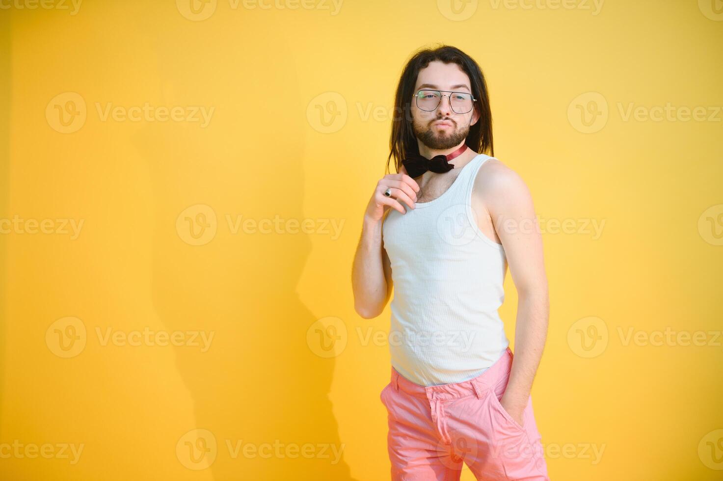 Gay man on a colored background in the studio. The concept of the LGBTQ community. Equality. photo