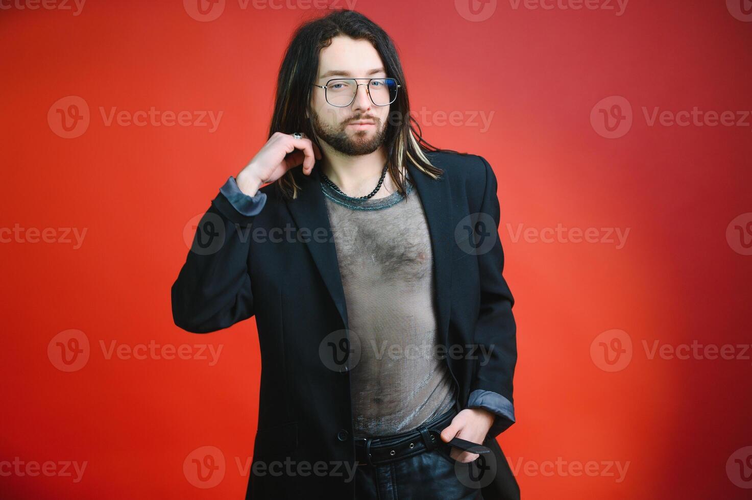Gay man on a colored background in the studio. The concept of the LGBTQ community. Equality. photo