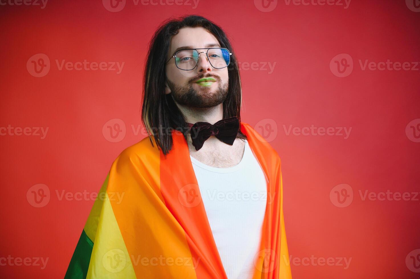 Youth transgender LGBT with Rainbow flag on shoulder isolated color background. gender expression pride and equality concept. photo
