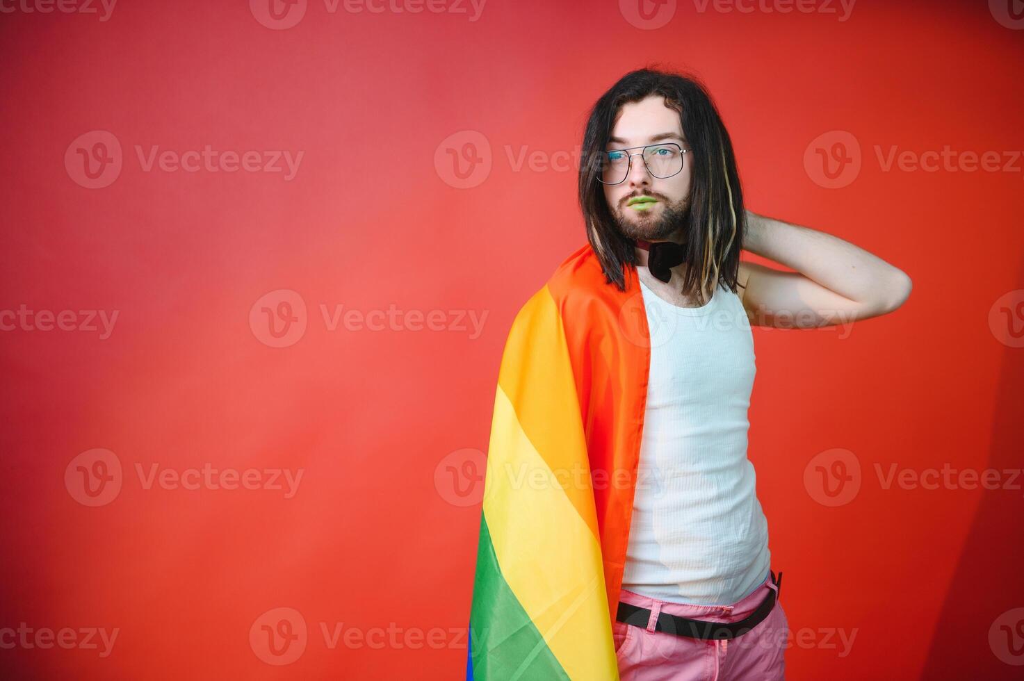 Youth transgender LGBT with Rainbow flag on shoulder isolated color background. gender expression pride and equality concept. photo