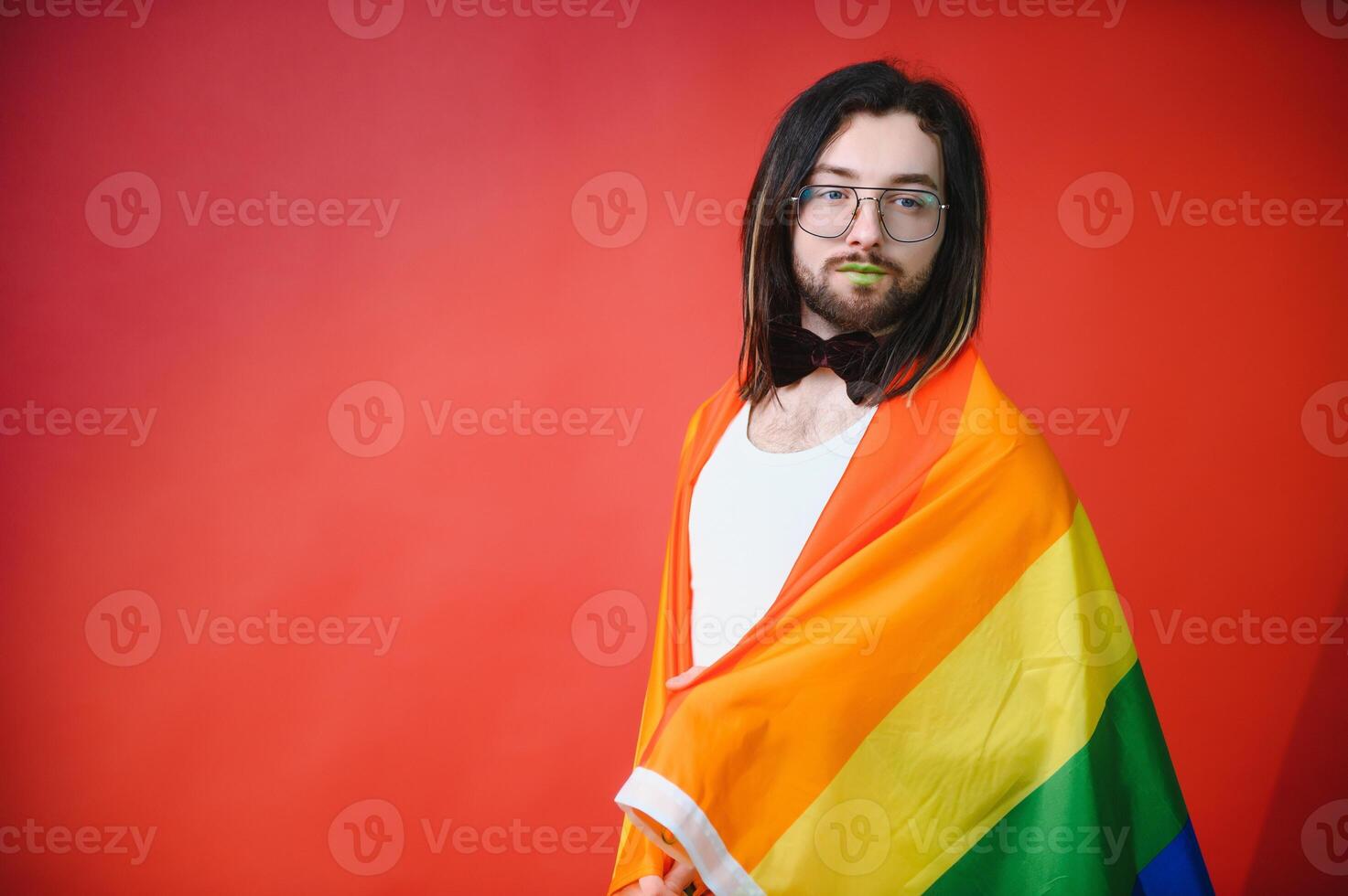 Youth transgender LGBT with Rainbow flag on shoulder isolated color background. gender expression pride and equality concept. photo