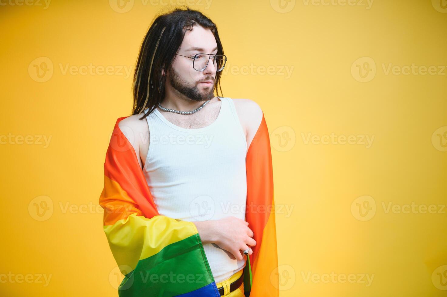 Youth transgender LGBT with Rainbow flag on shoulder isolated color background. gender expression pride and equality concept. photo