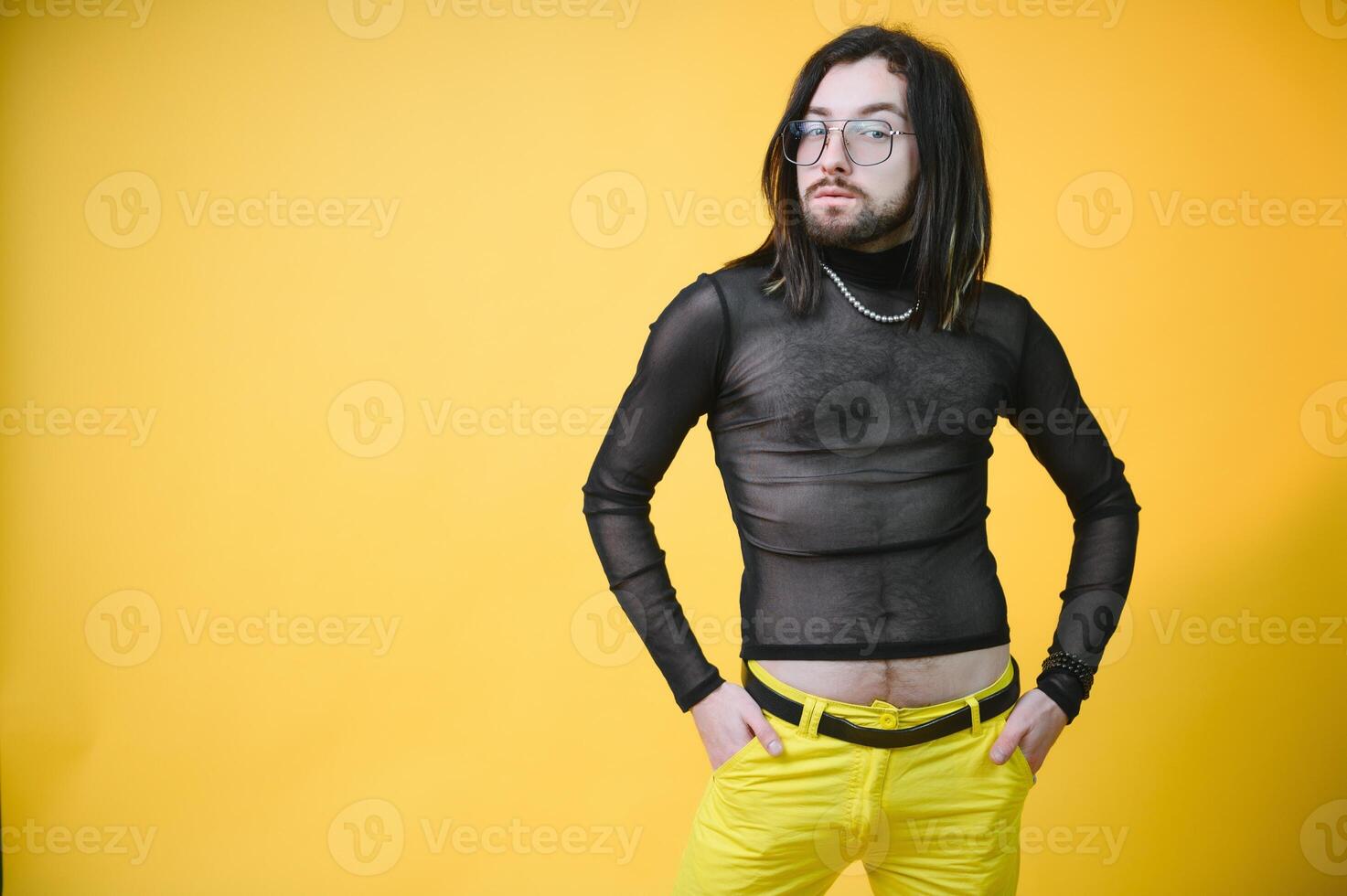 Gay man hold rainbow striped flag isolated on colored background studio portrait. People lifestyle fashion lgbtq concept photo