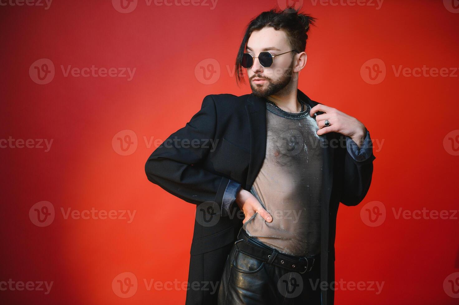 Young, handsome gay man on a colored background in the studio. LGBT concept. photo