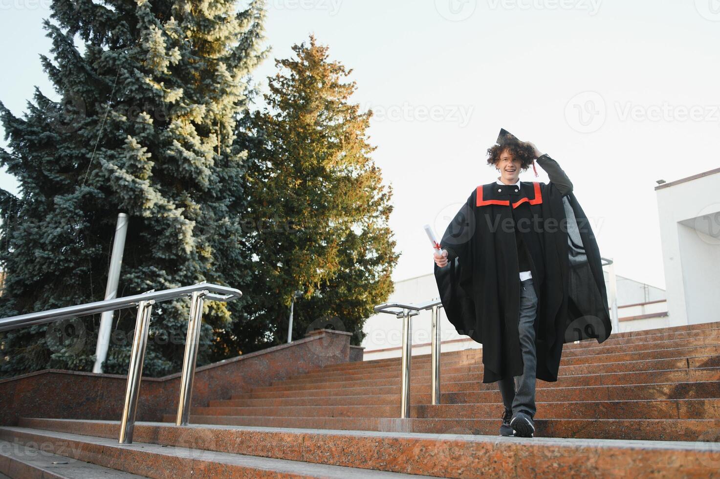 Excited male student in mantle scream graduate from university finish course studying. Happy man triumph holding college diploma in hands overjoyed with high school graduation. photo