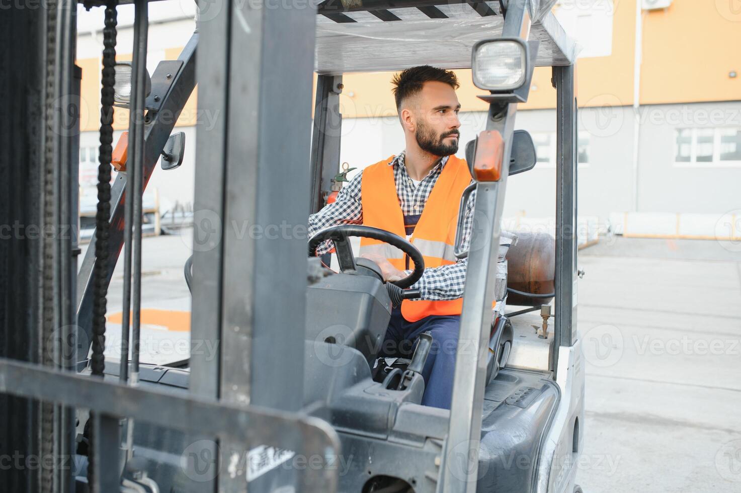 Waving forklift driver in the warehouse of a haulage company while driving forklift photo
