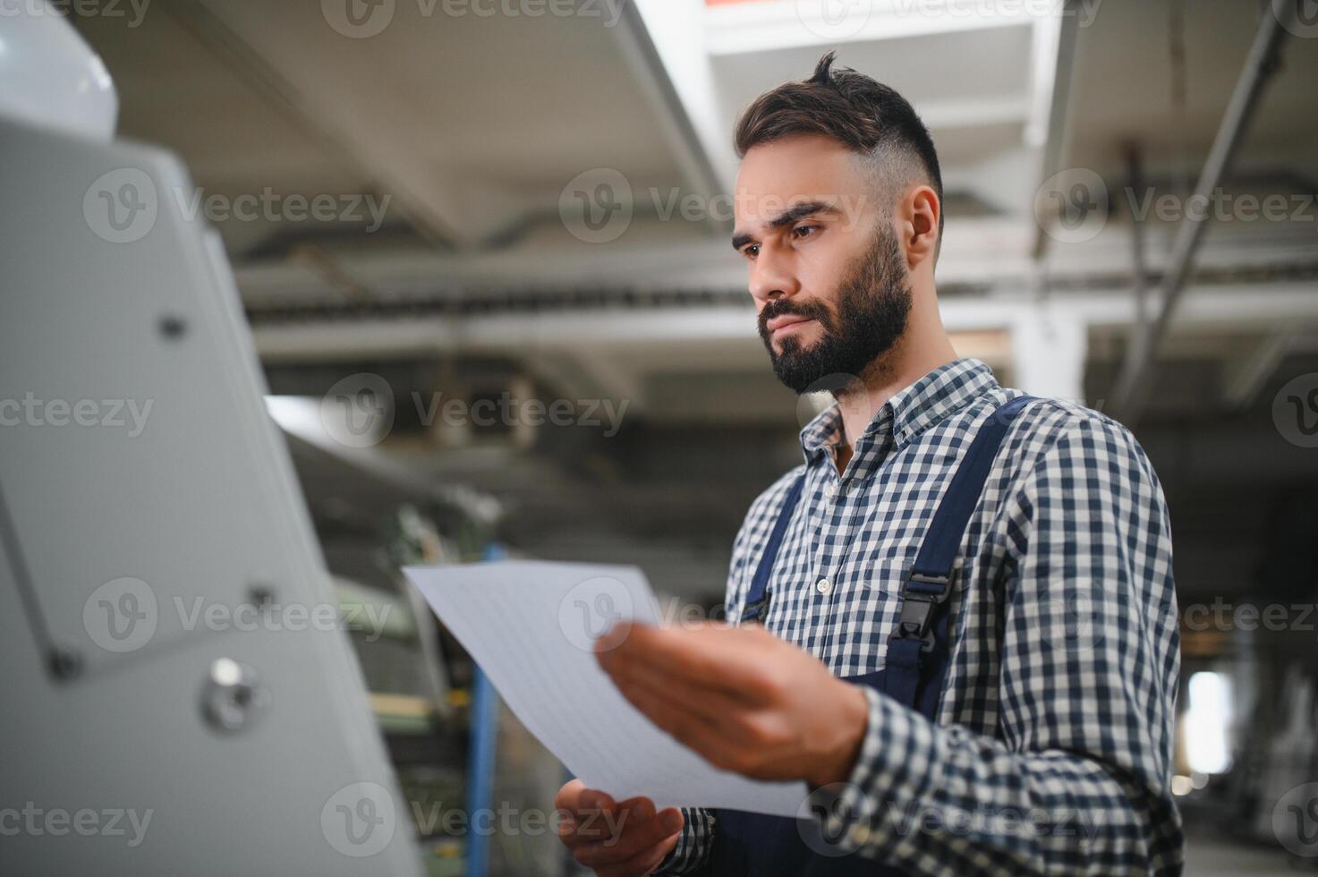 worker operating machine in factory photo