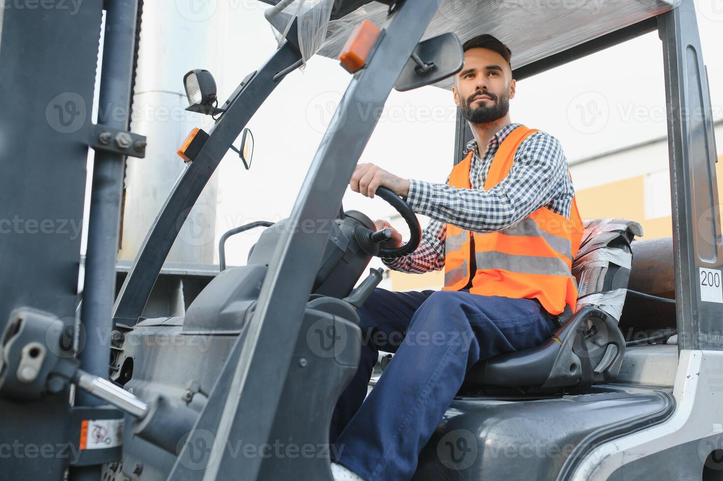 Waving forklift driver in the warehouse of a haulage company while driving forklift photo