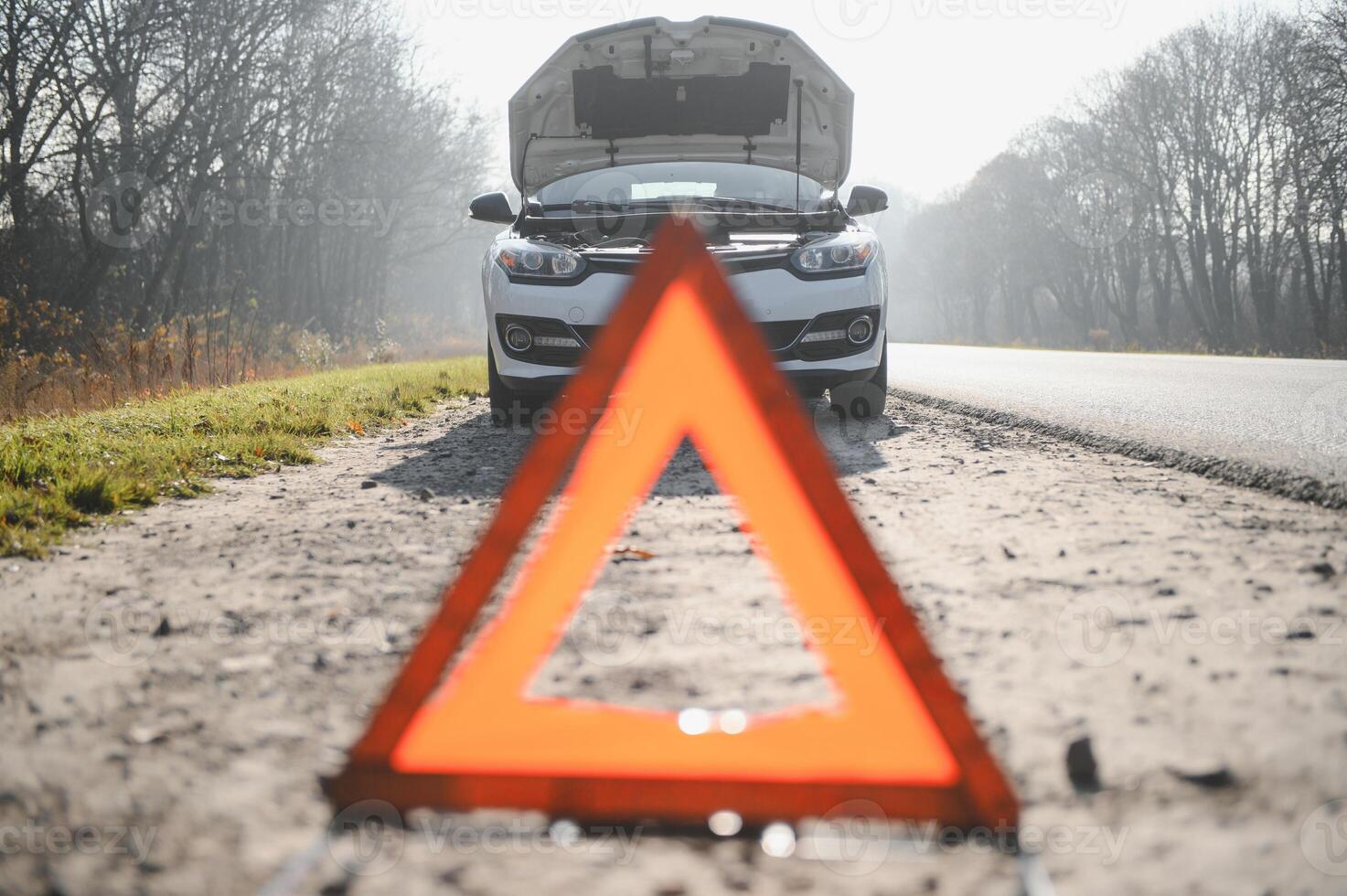 Broken car concept, breakdown triangle on road photo