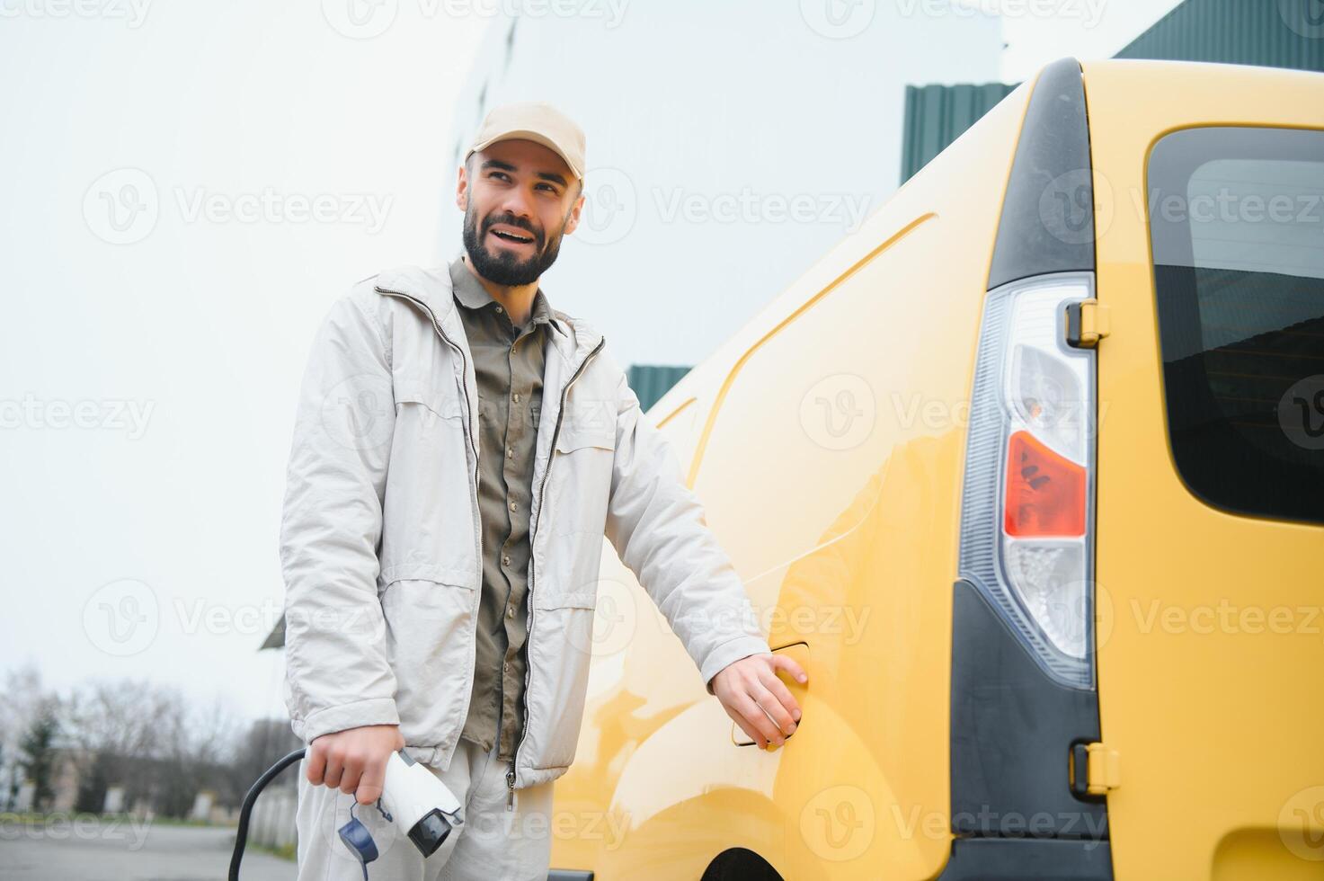 Man holding power connector for electric car photo