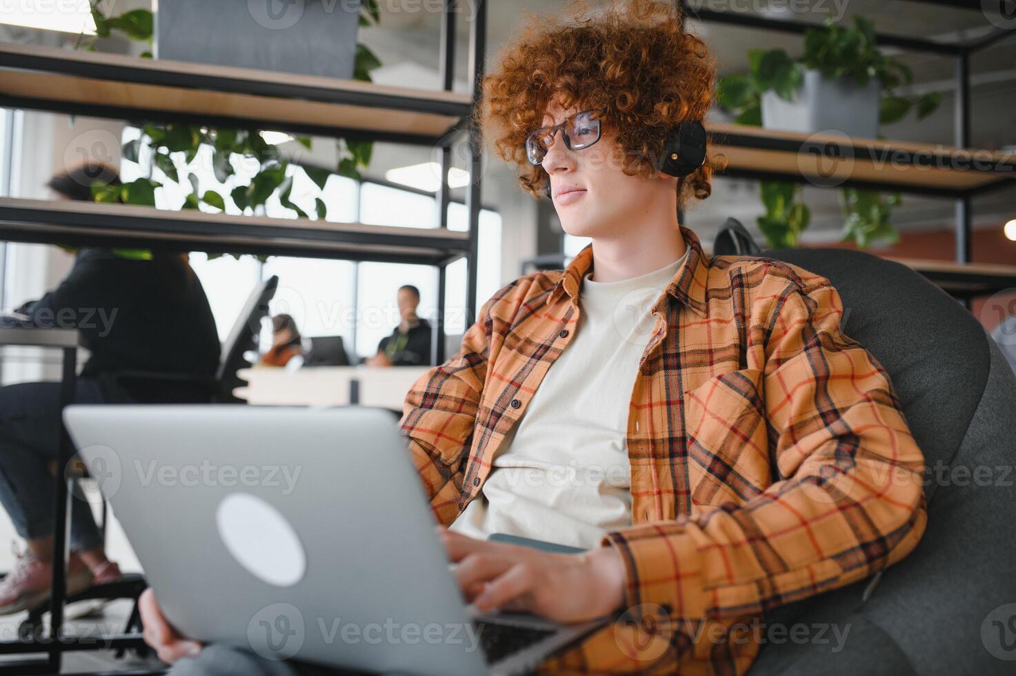 male programmer wear spectacles for eyes protection while working on freelance via laptop computer,clever student watching tutorial on netbook. photo