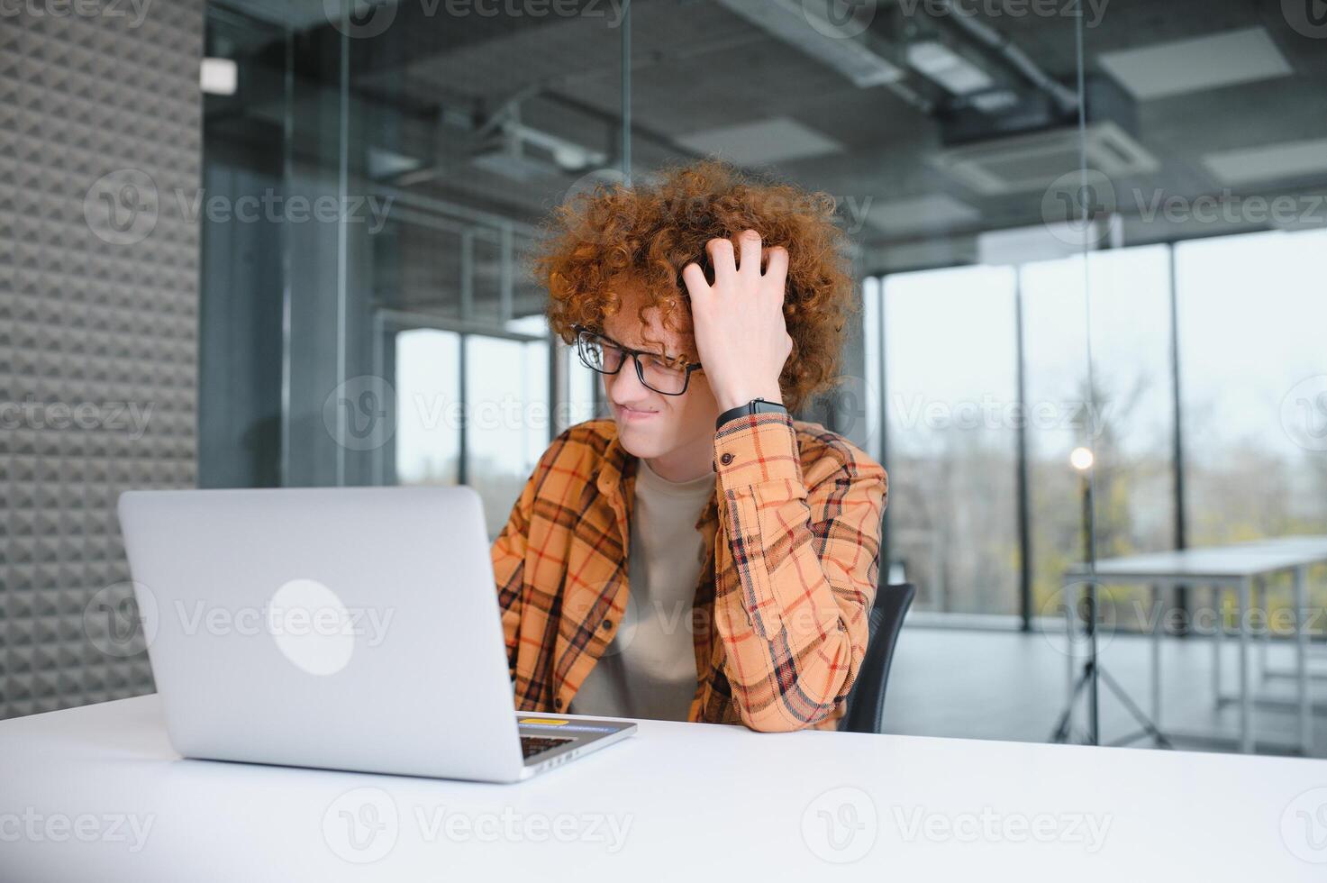 male programmer wear spectacles for eyes protection while working on freelance via laptop computer,clever student watching tutorial on netbook. photo