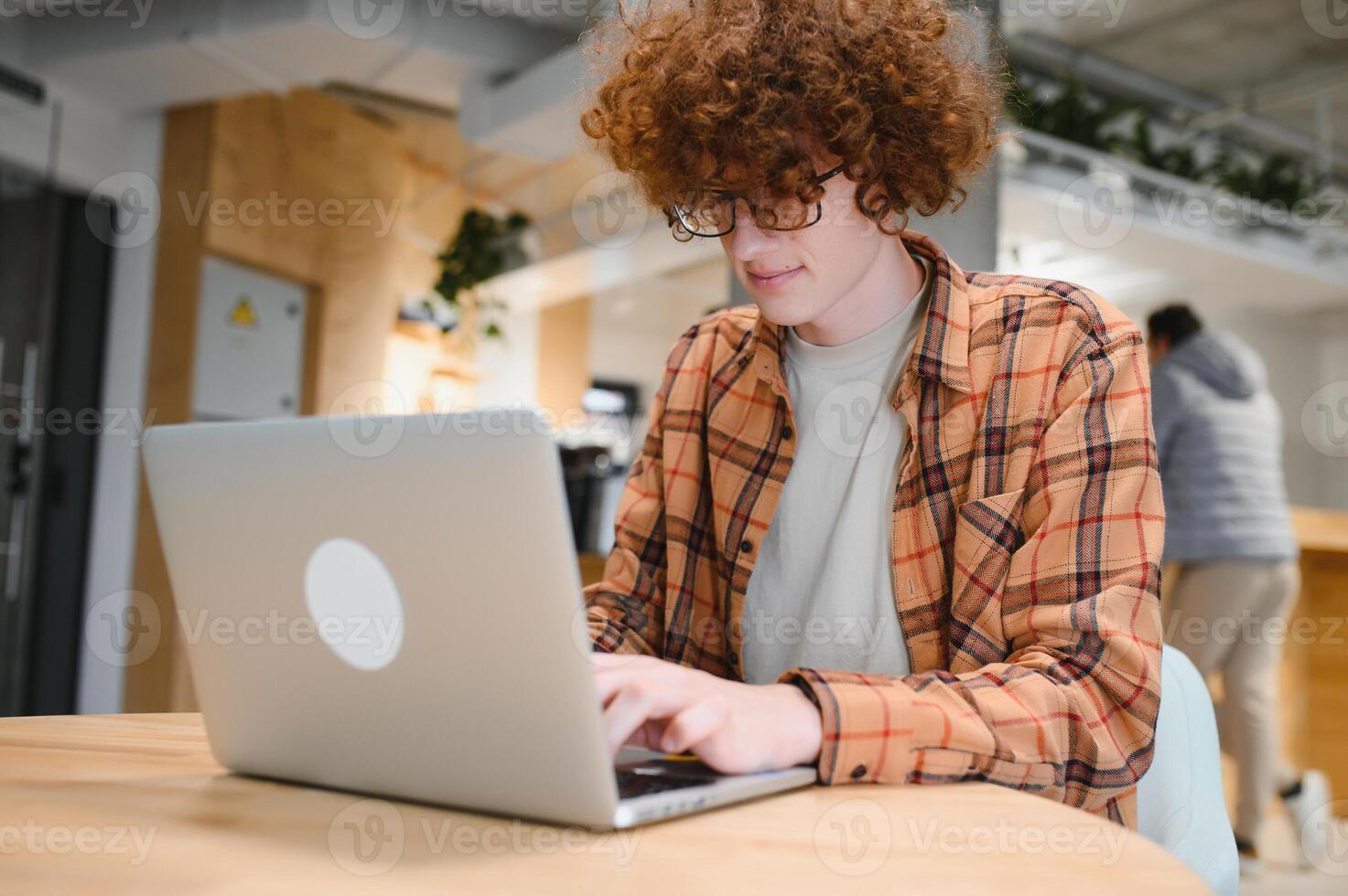 male programmer wear spectacles for eyes protection while working on freelance via laptop computer,clever student watching tutorial on netbook. photo
