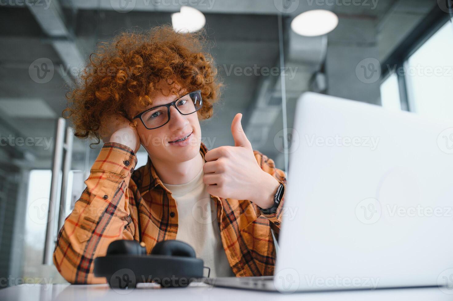 male programmer wear spectacles for eyes protection while working on freelance via laptop computer,clever student watching tutorial on netbook. photo