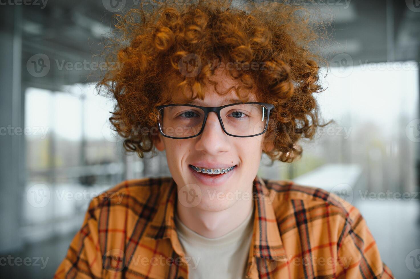 cute red-haired guy wearing stylish glasses yellow t-shirt. photo