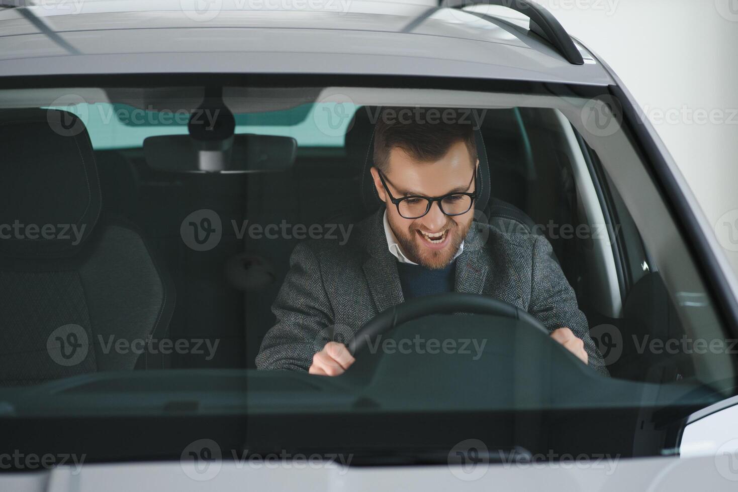 His true love. Portrait of a mature man smiling happily sitting in a brand new car photo