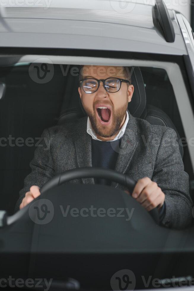 His true love. Portrait of a mature man smiling happily sitting in a brand new car photo