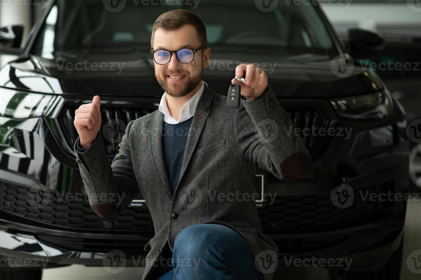 Young man with the keys at the car photo