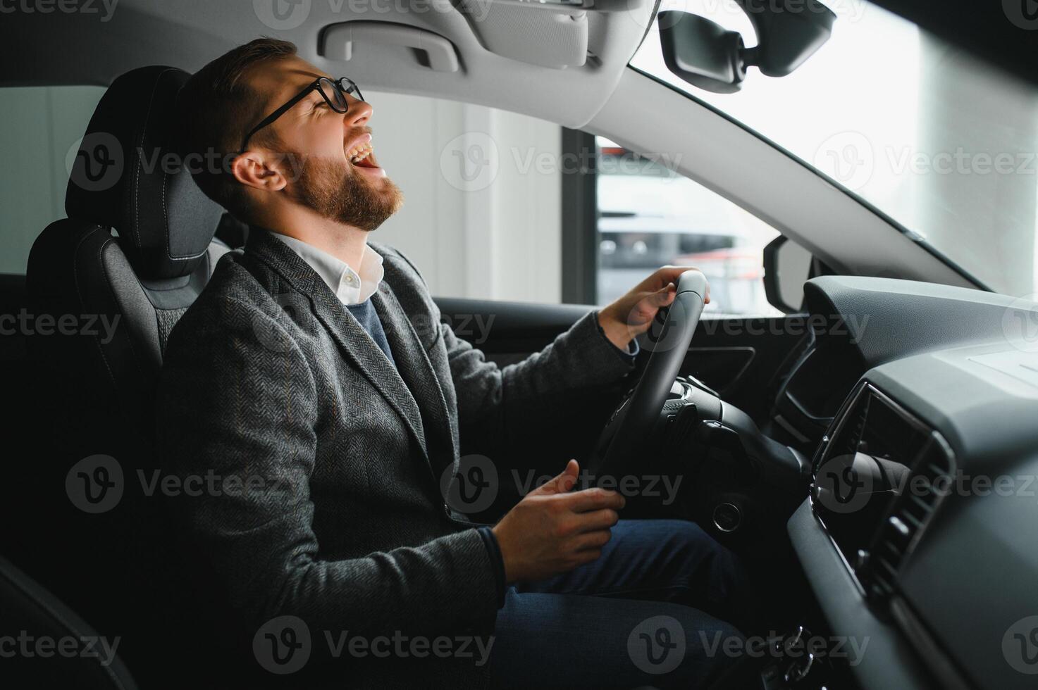His true love. Portrait of a mature man smiling happily sitting in a brand new car photo