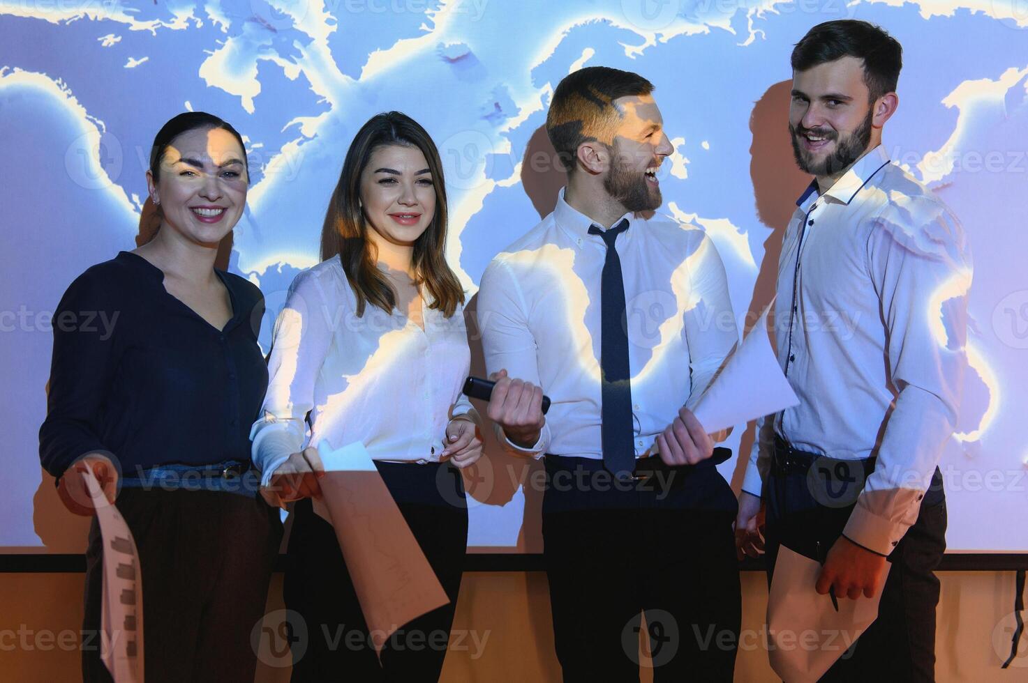 Image of businesspeople standing against world map background photo