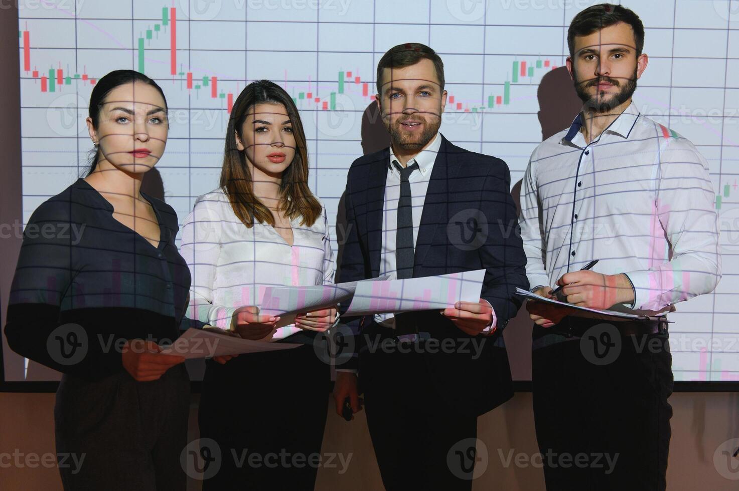 Group of business people working at modern office.Technical price graph, red and blue candlestick chart and stock trading computer screen background. Double exposure. Traders analyzing data photo