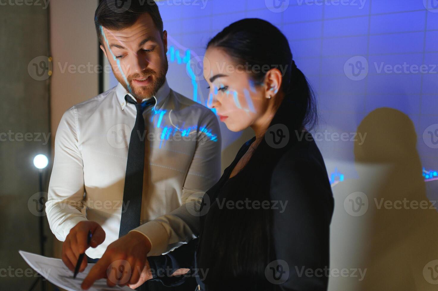 Group of business people working. Technical price graph and indicator, red and blue candlestick chart and stock trading computer screen background. Traders analyzing data photo