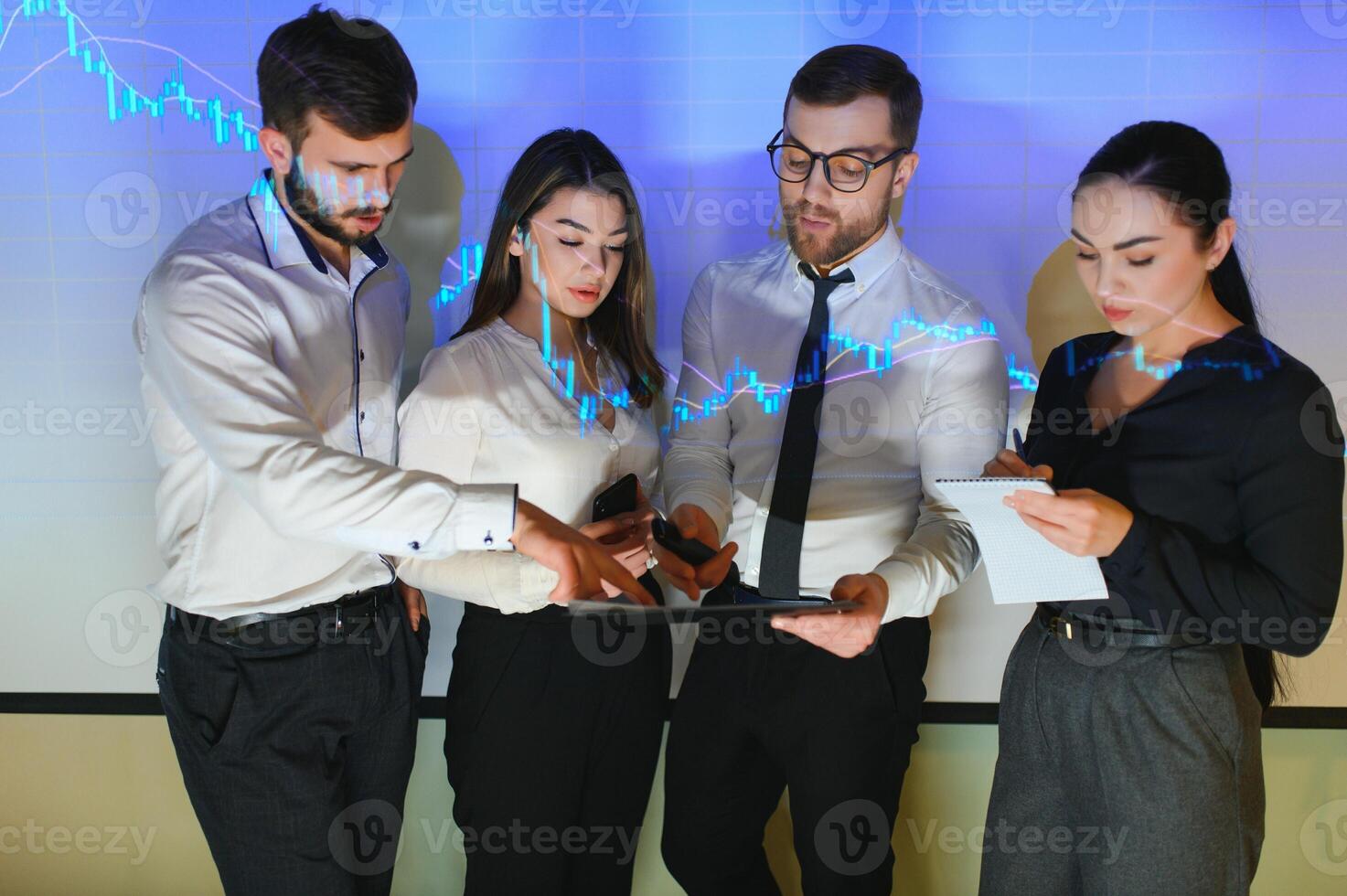 Group of business people working at modern office.Technical price graph, red and blue candlestick chart and stock trading computer screen background. Double exposure. Traders analyzing data photo