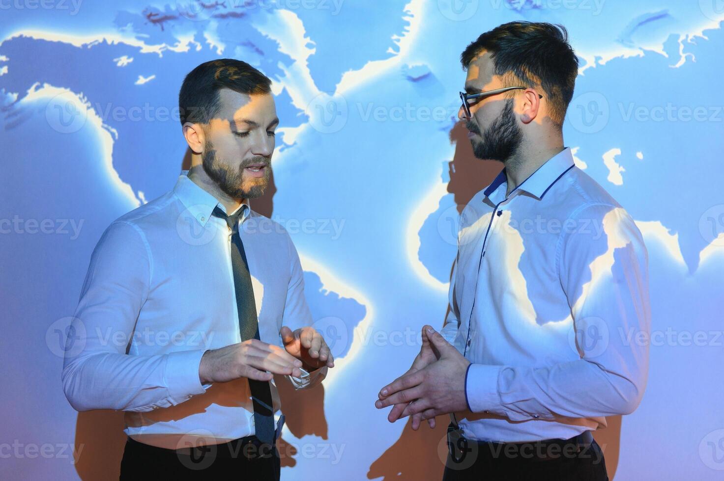 Handshake with map of the world in background photo