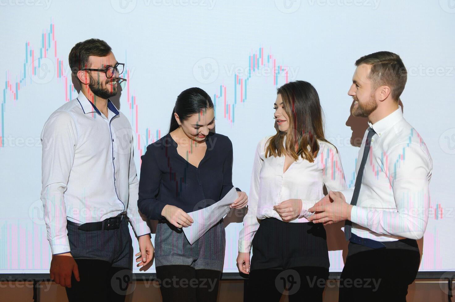 Group of business people working at modern office.Technical price graph, red and blue candlestick chart and stock trading computer screen background. Double exposure. Traders analyzing data photo