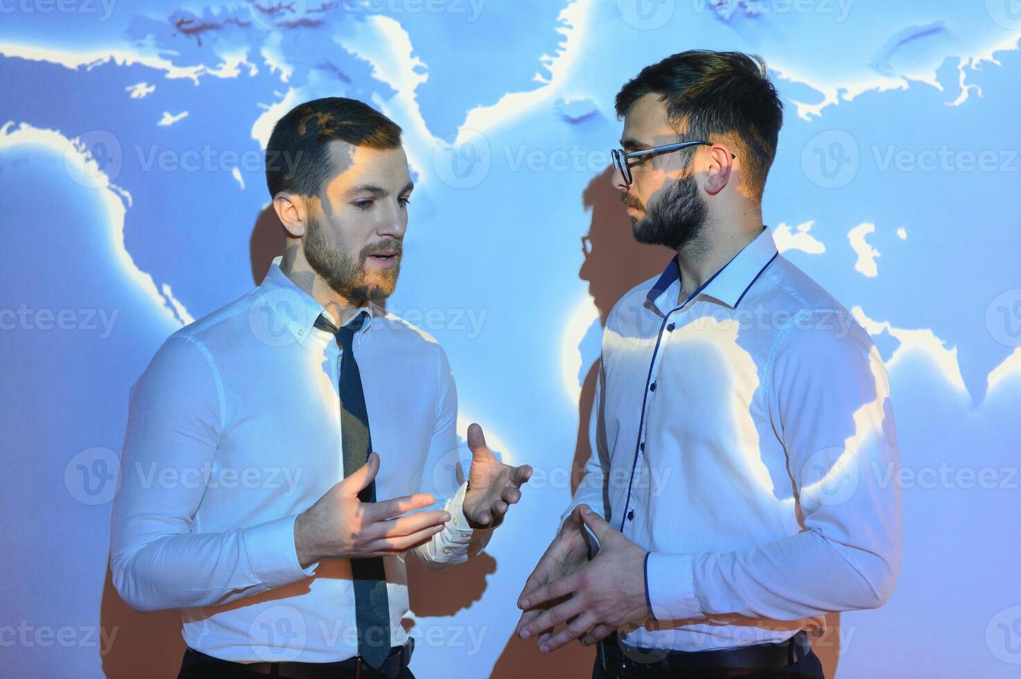 Handshake with map of the world in background photo