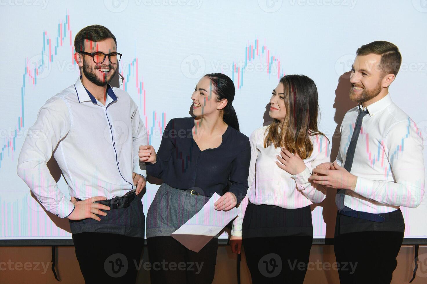 Group of business people working at modern office.Technical price graph, red and blue candlestick chart and stock trading computer screen background. Double exposure. Traders analyzing data photo