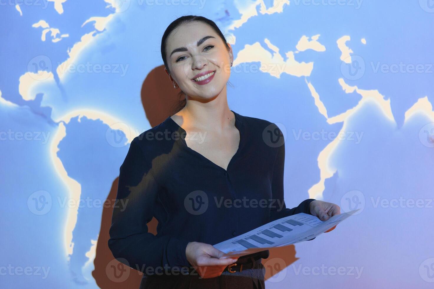 Globe business concept - happy business woman with world map background. photo